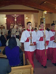 Archconfraternity members lead the recessional after Mass